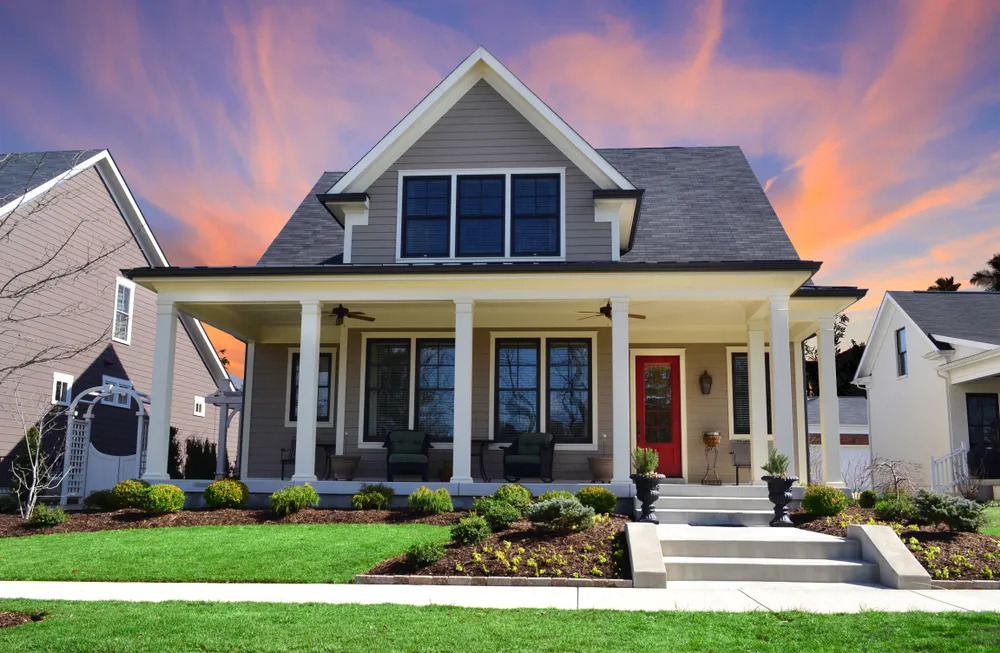 Charming house with porch at sunset.